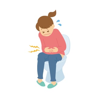 トイレで腹痛に苦しむ女性